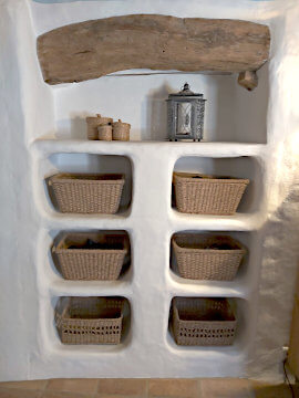 A rustic shelf unit build into the wall